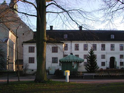 Byggnader med en gul postlåda framför i Vadstena kloster.