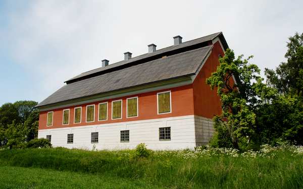 Tuna kungsgård i rött och vitt med svart tak.